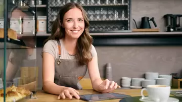 Frau hinter der Theke eines Cafes